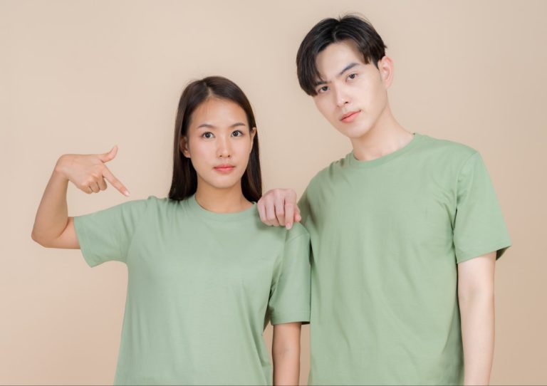 An image of a male and female fashion model standing in green t-